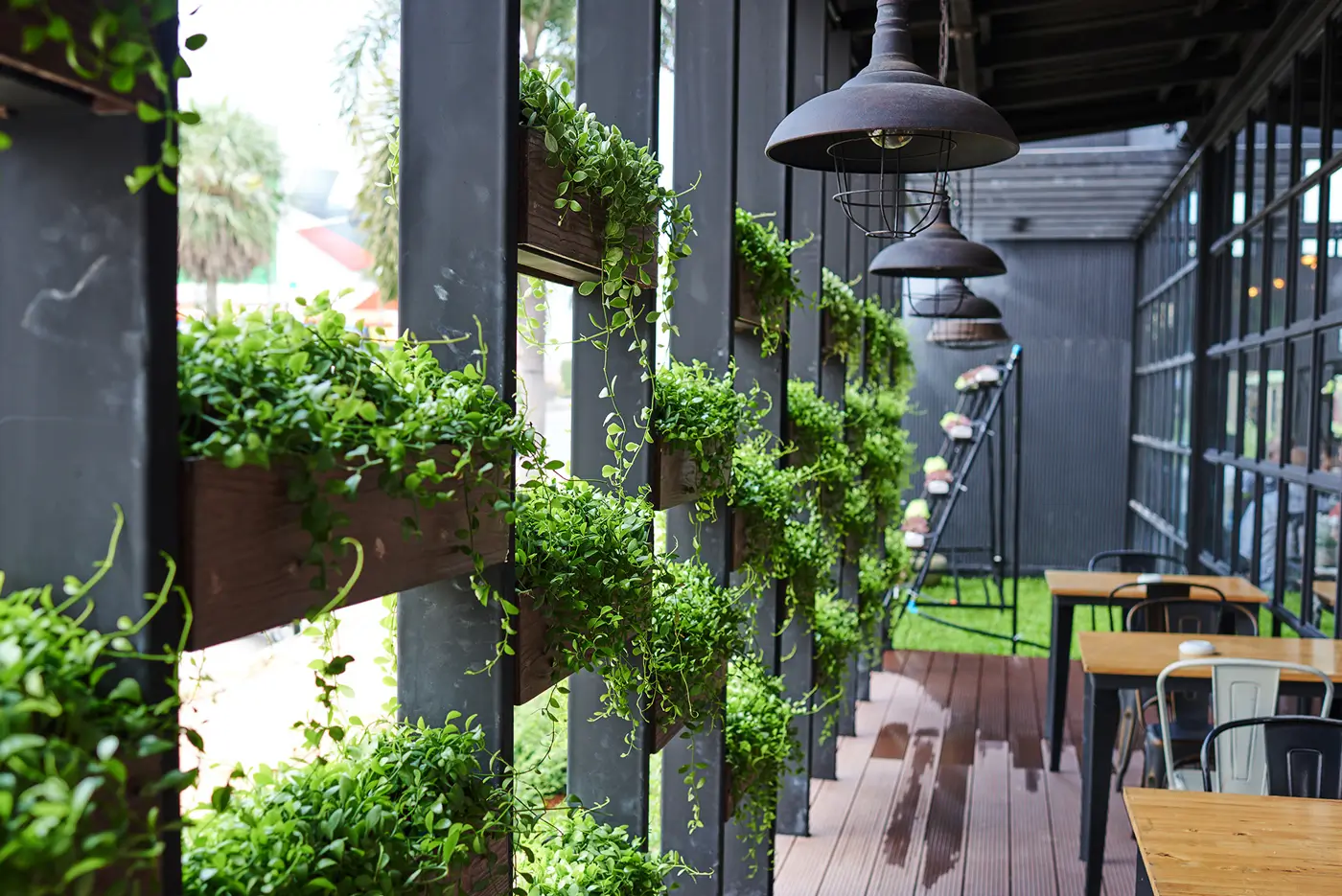 A patio with plants growing on the side of it.